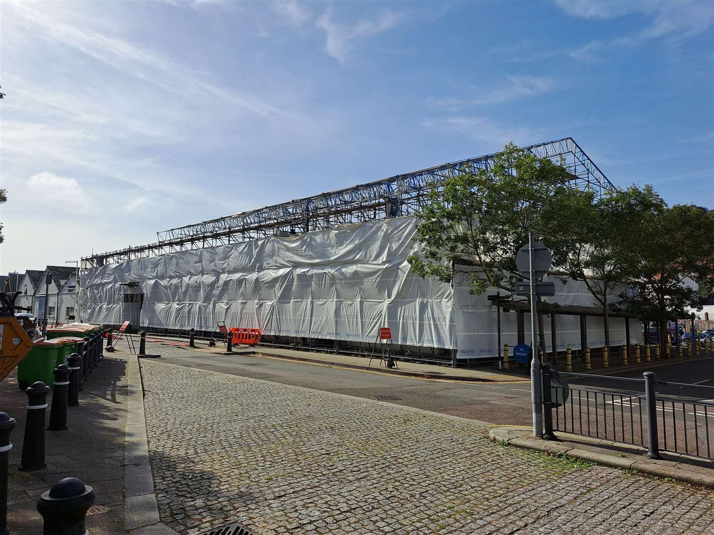 Tarpaulin was erected around De Bradelei Wharf in August, ahead of its demolition