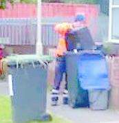 A Serco worker mixing recycling that had already been sorted by resident
