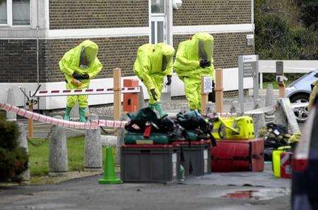 Fire crews put on their protective suits at Folkestone police station