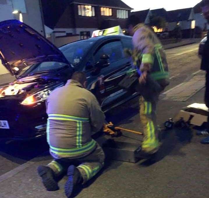 Fire fighters tried to coax the kitten out from the engine. Picture: Pass Driving School