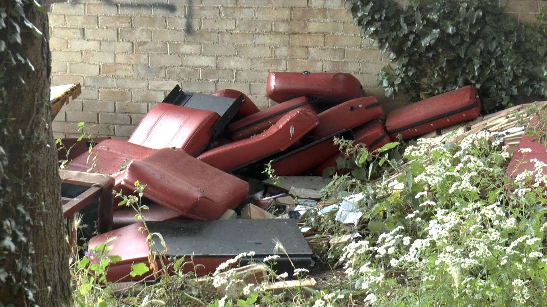 Unwanted office furniture piled high in the residential street