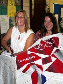 Sheppey artist Paula Trower and Catherine Herbert, Swale Borough Council'­s arts and heritage officer, cutting up the flag which was used as part of a public art project earlier this year.