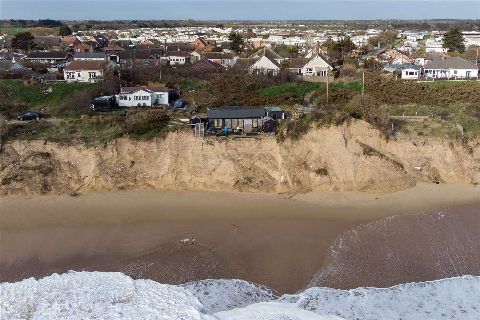 Lance Martin stands in the back garden of his home in Hemsby, Norfolk, where his back door is now no more than six metres from the cliff edge (Joe Giddens/PA)