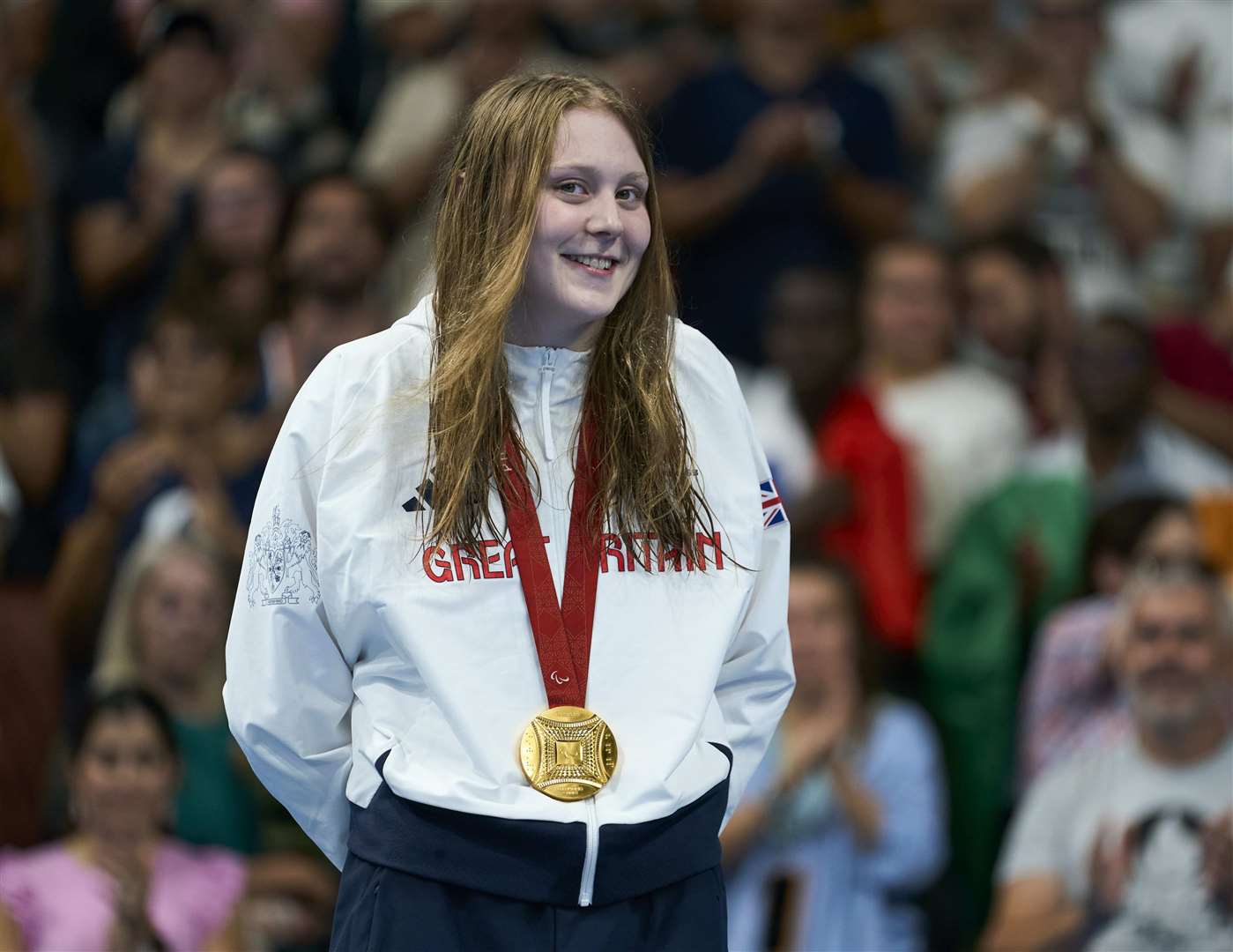 Poppy Maskill on the podium after winning the gold medal in the women’s 100m butterfly (ParalympicsGB/PA)