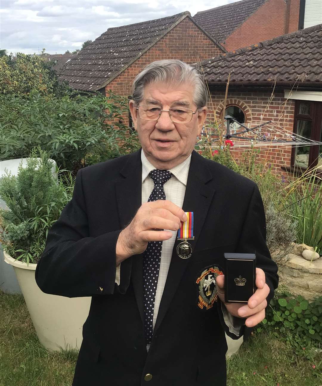 Terry Quinlan with the medal that he has been waiting for since 1957