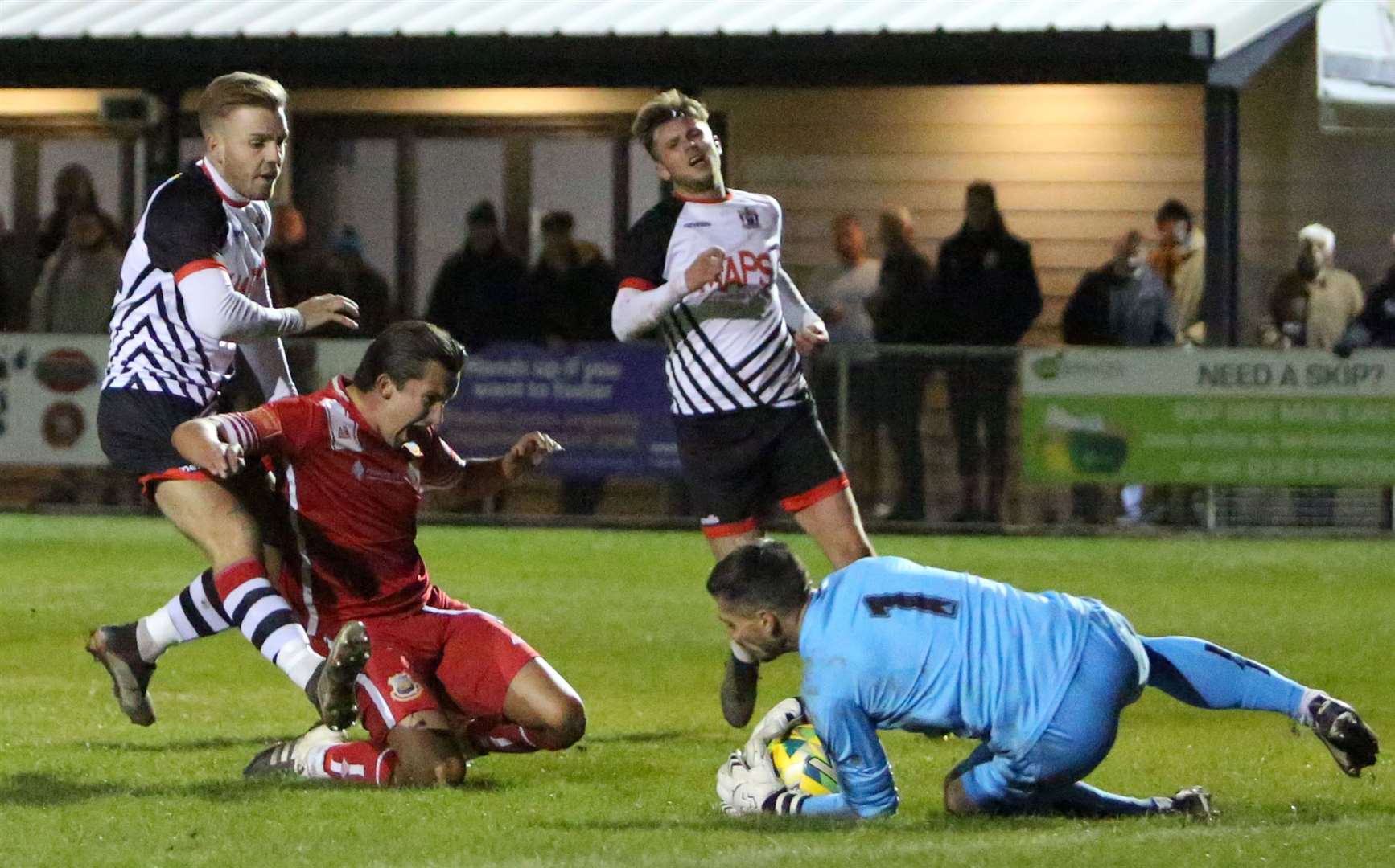 Whitstable goalkeeper Dan Eason saves at the feet of Deal's Aaron Millbank. Picture: Paul Willmott