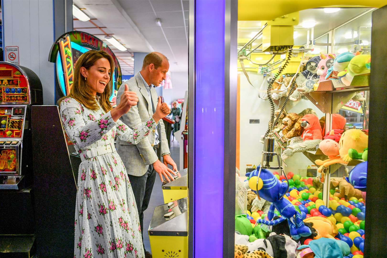 The Duke and Duchess of Cambridge play a grab a teddy game as the duchess picks up a blue toy and celebrates with thumbs up, only for it to slip from the claws (Ben Birchall/PA)