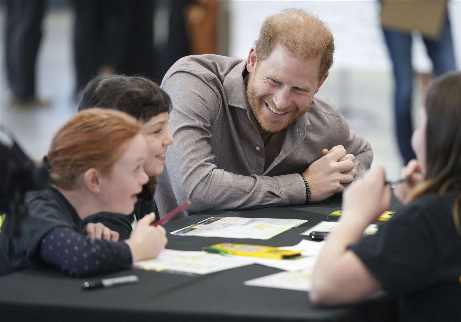 Prince Harry talks with students from Shaughnessy Elementary School during an event to launch the Invictus Games school program (Darryl Dyck/The Canadian Press via AP)