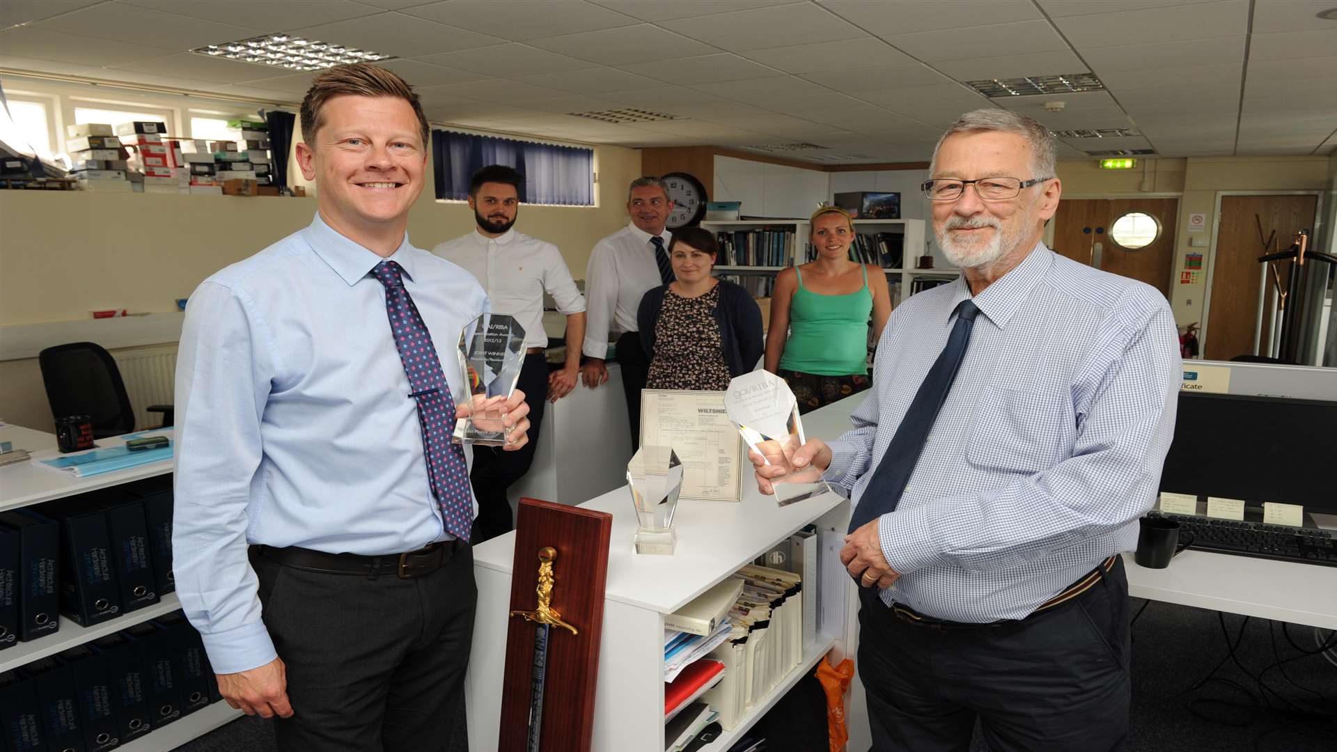 The John Planck Ltd team with awards won for projects like the renovation of the Royal Opera House