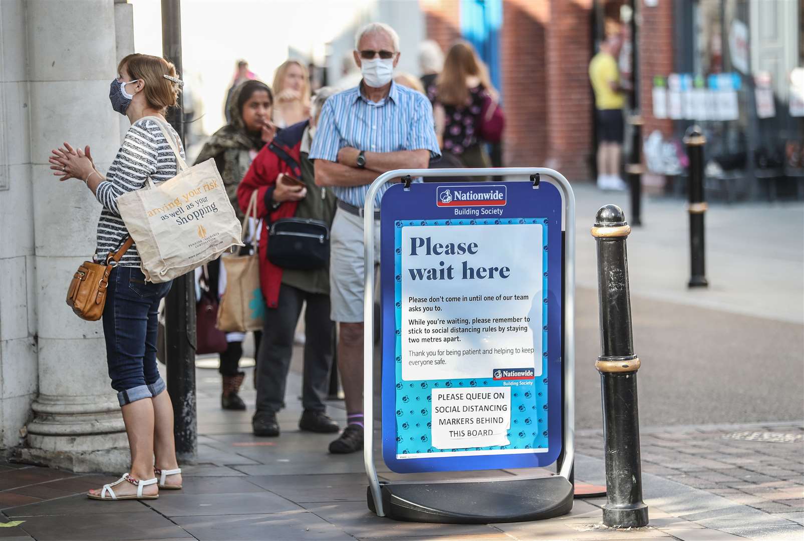 Customers in a socially distanced queue outside Nationwide Building Society in the High Street in Worcester (David Davies/PA)