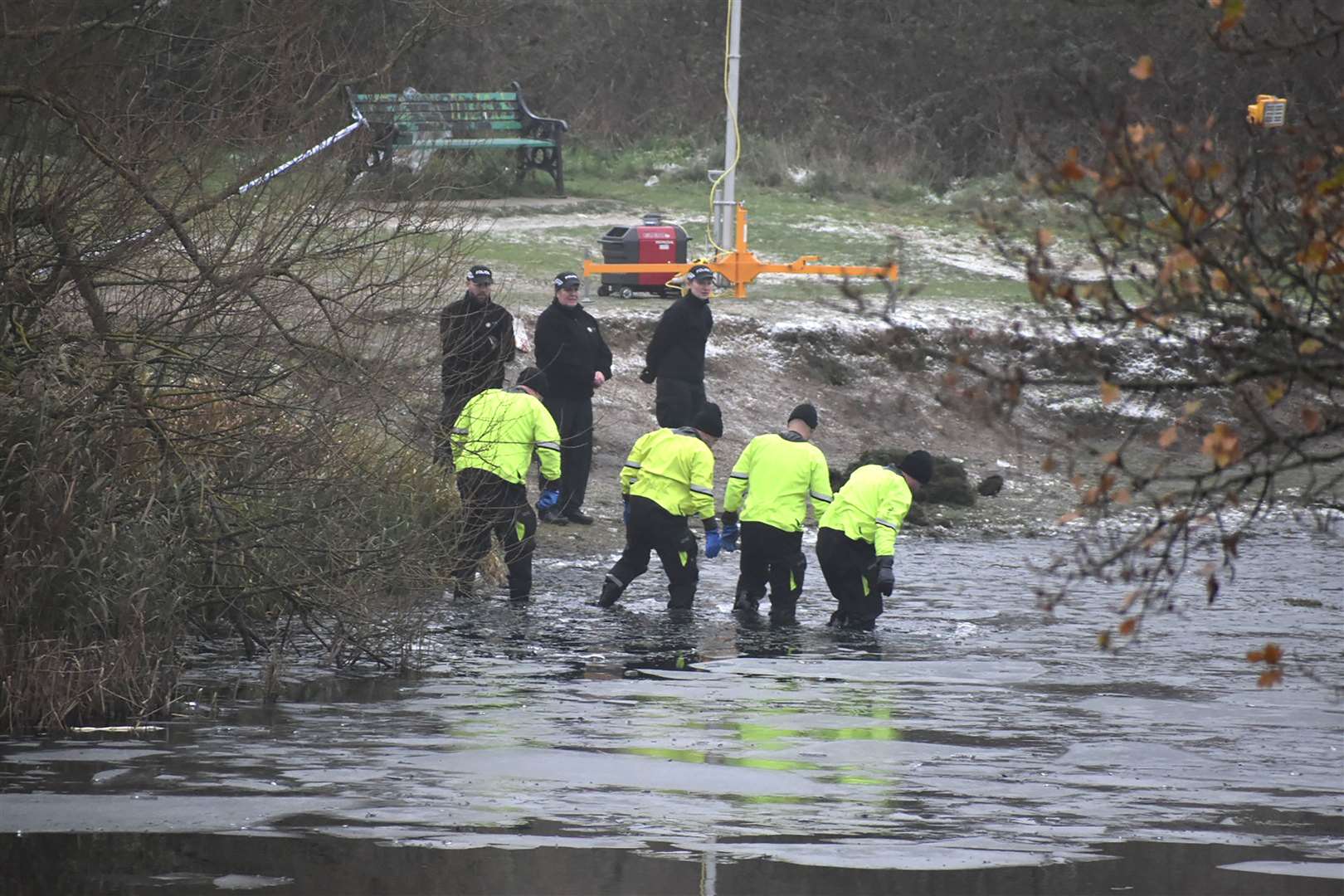 Police search teams at the scene in Babbs Mill Park in Kingshurst, Solihull, where three children died after falling through ice (Matthew Cooper/PA)