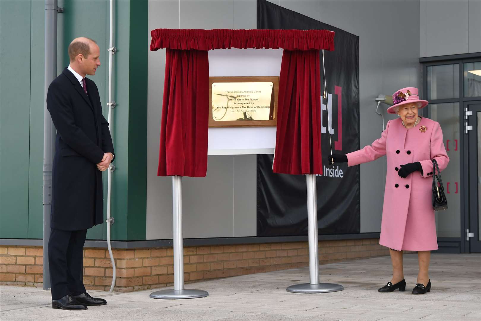 The Duke of Cambridge watches as the Queen unveils a plaque at the Defence Science and Technology Laboratory at Porton Down (Ben Stansall/PA)