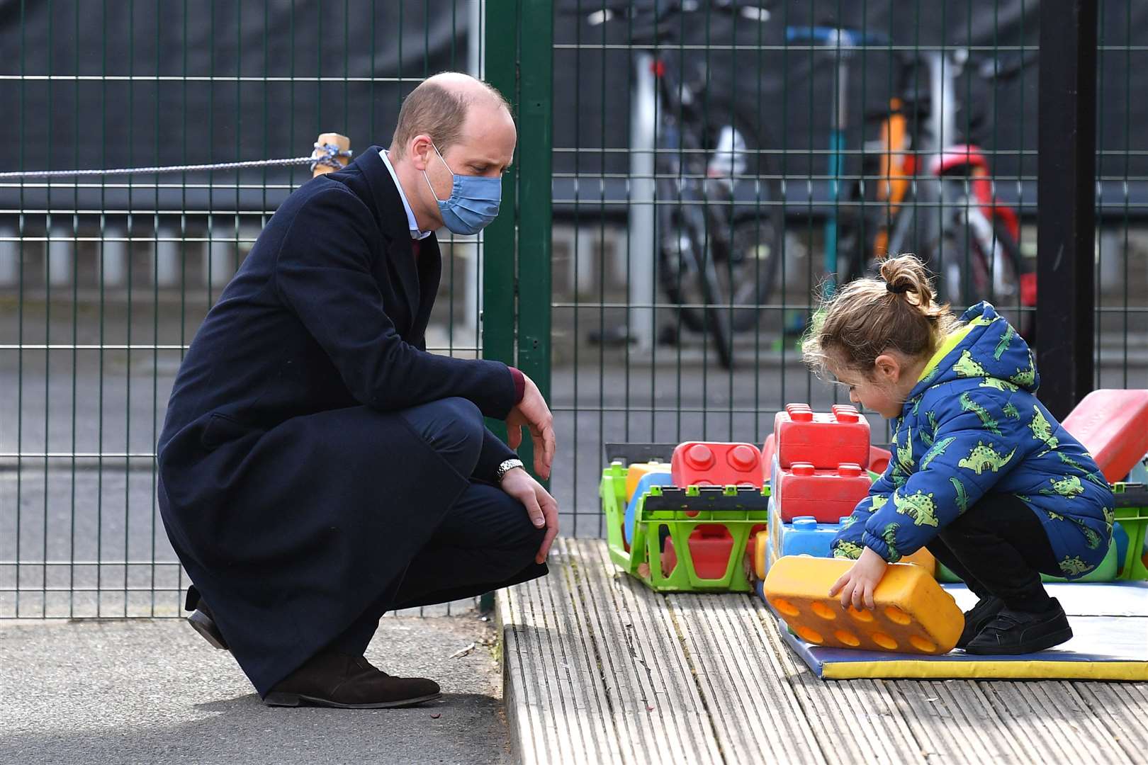 William with a little girl in the playground (Justin Tallis/PA)