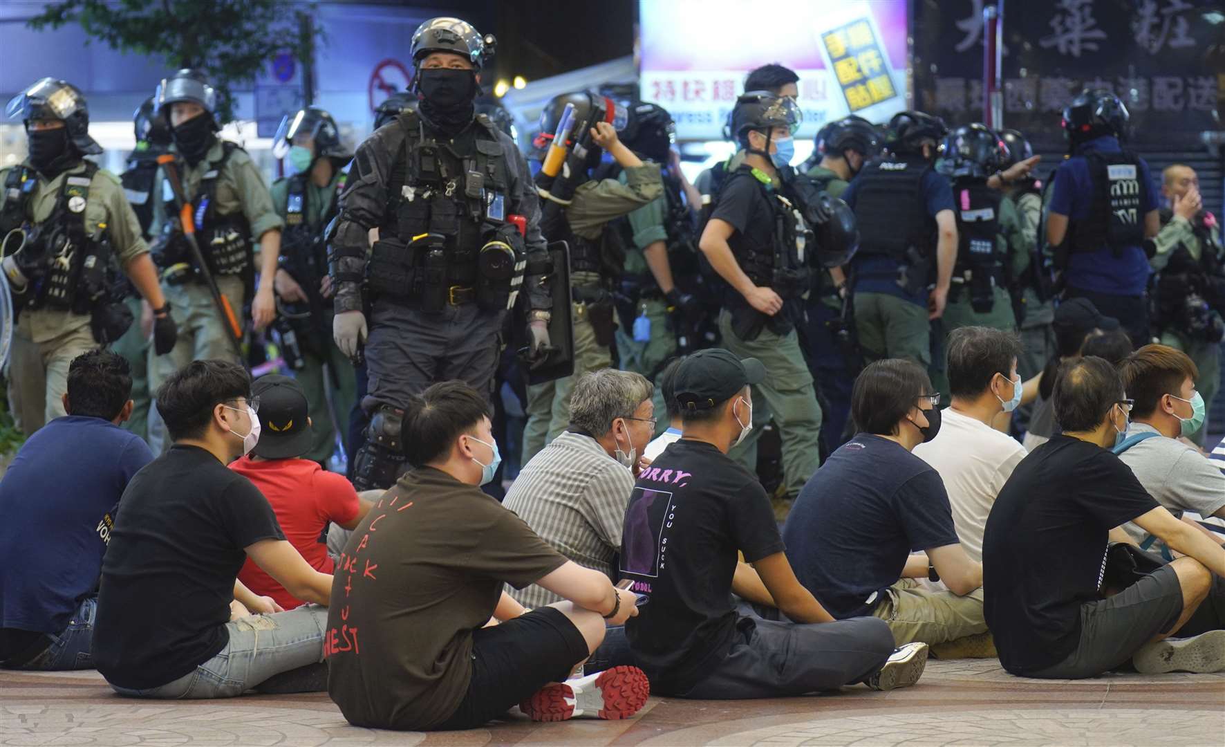 Police detain protesters against the new security law during a march marking the anniversary of the Hong Kong handover from Britain to China (Vincent Vu/AP)