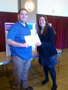 Andrew Cox receiving a certificate for 150lb weight loss from his leader, Kerry Goldsmith. He has since gone on to lose more than 11 stone.