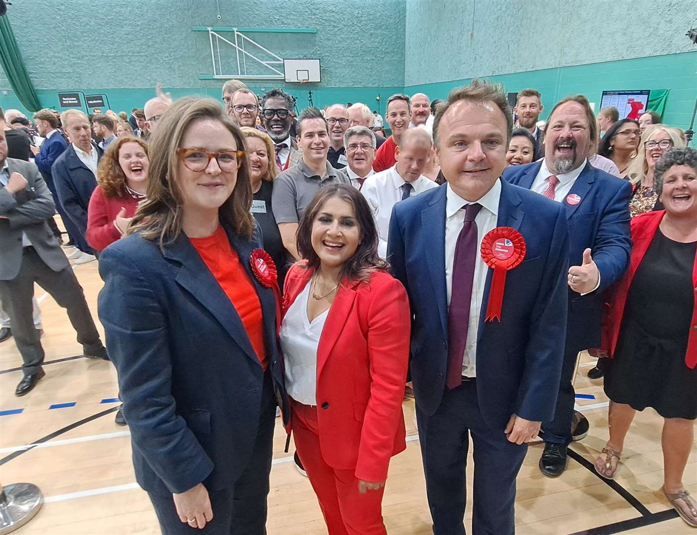 Left to right: Medway's new Labour MPs Lauren Edwards, Naushabah Khan and Tristan Osborne stand in front of supporters at Medway Park
