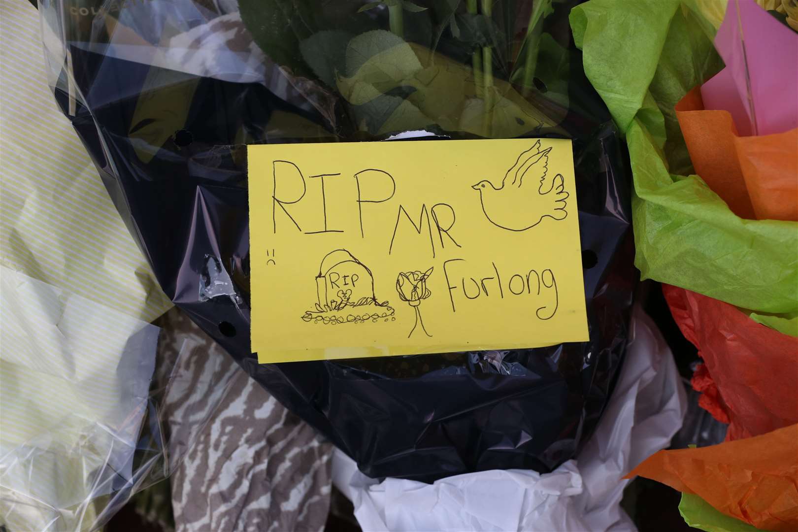 Notes left on flowers placed in front of the Post Office in Reading town centre (Jonathan Brady/PA)