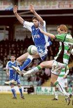 Darren Dennehy battles for the ball with Shaun MacDonald