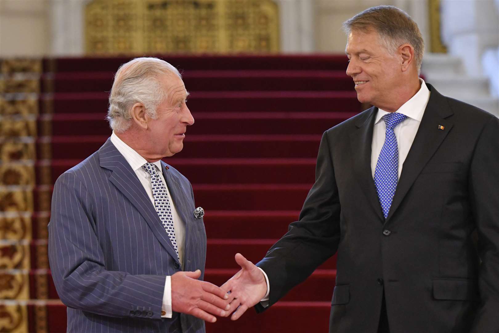 The is greeted by Romanian president Klaus Iohannis (Alexandru Dobre/AP)