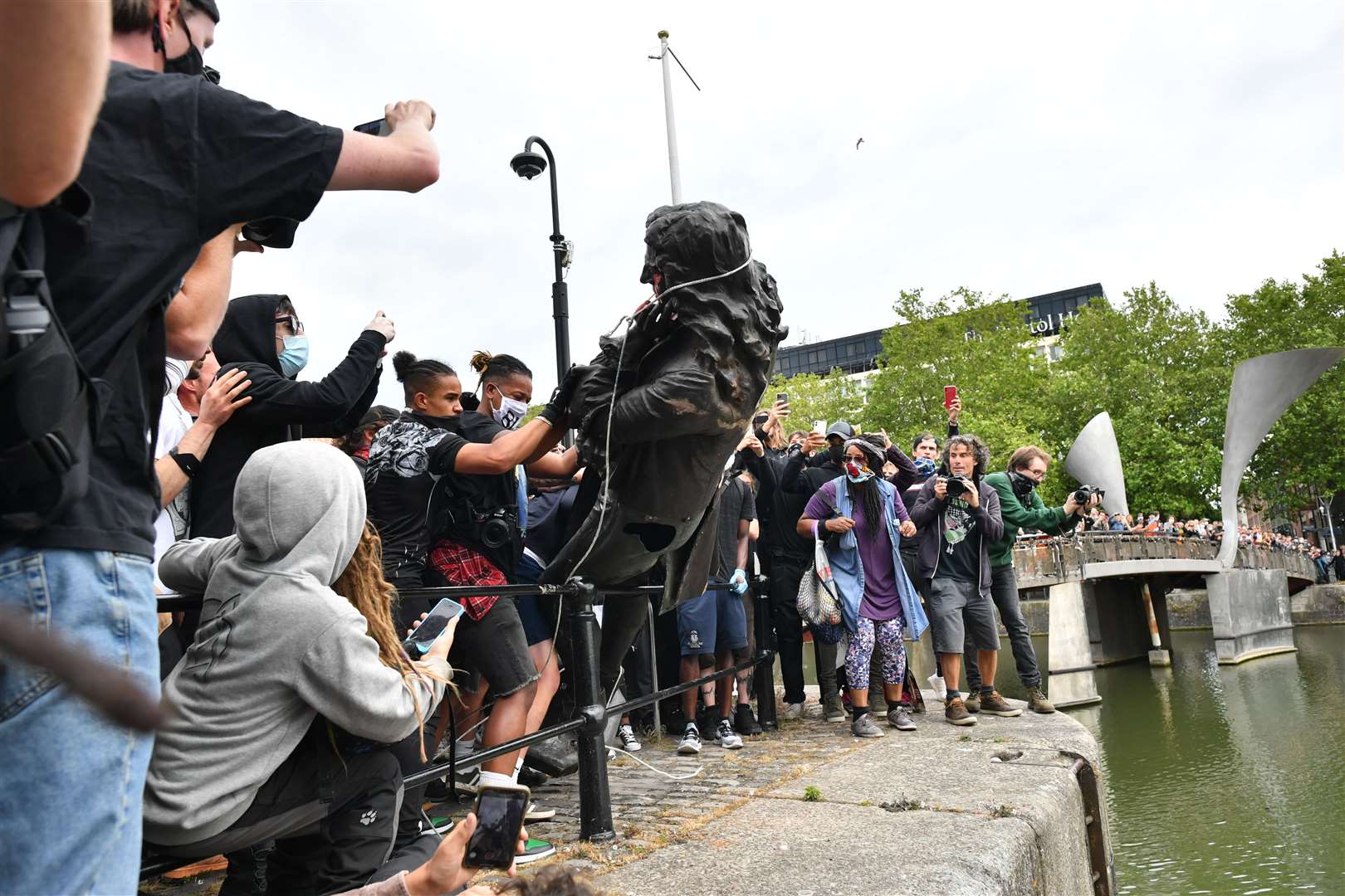 Protesters then throw the statue into Bristol harbour (Ben Birchall/PA)