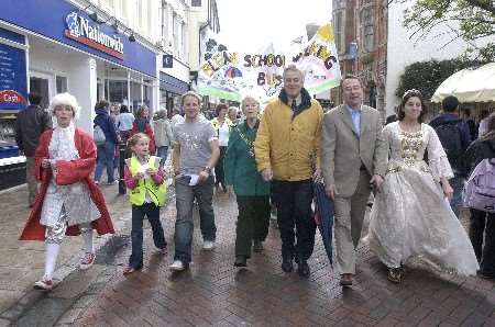 The Big Bus column heads through Canterbury led by Prince Charming, TV presenter George Wood, Lord Mayor Marion Attwood, Edwin Boorman, Graham Brown MD of Denne Group and Cinderella. Picture: CHRIS DAVEY