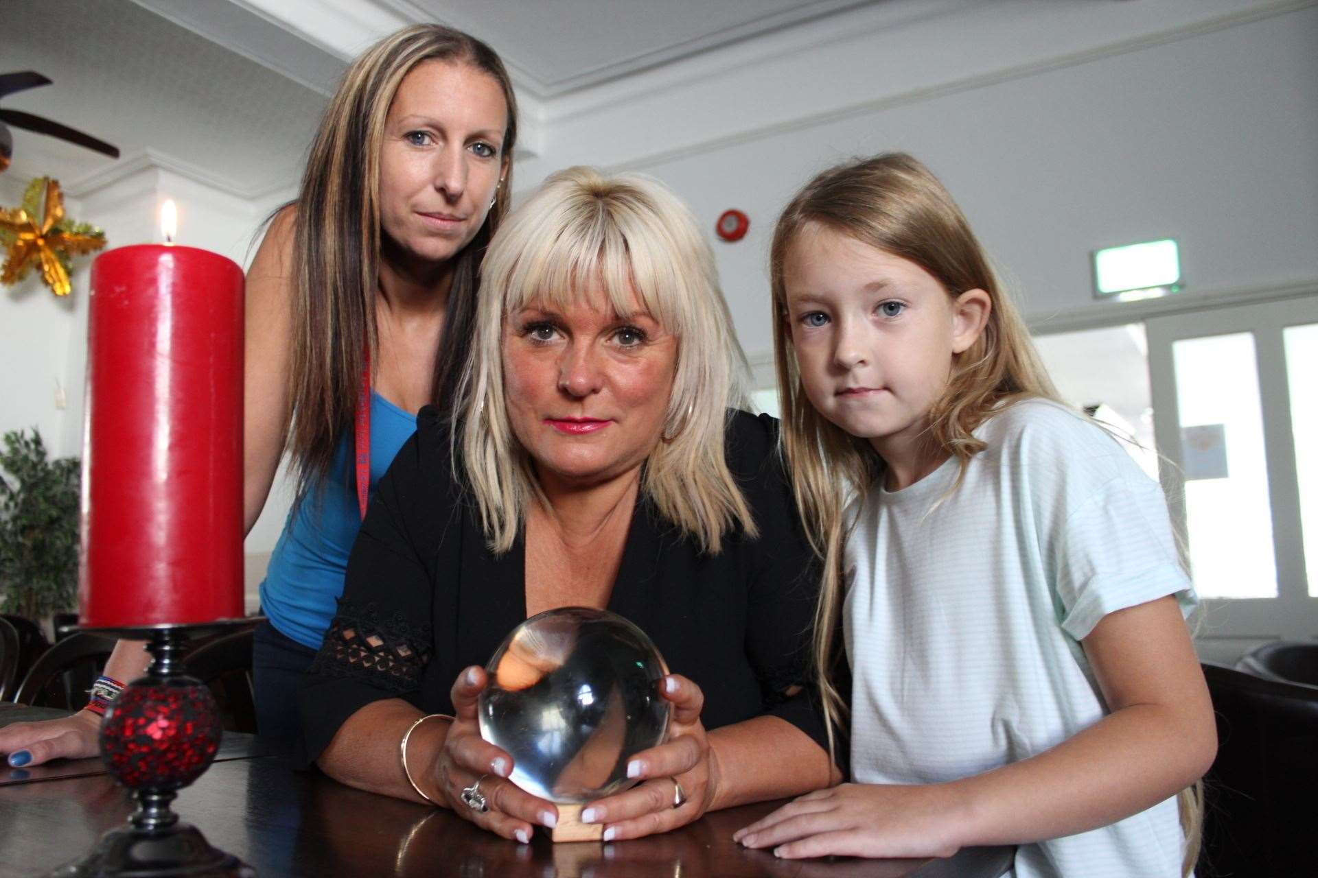 Sheppey psychic Charlotte Clark used her crystal ball to investigate spirits at the Royal Hotel, Sheerness, in 2017 pictured with manageress Sarah Lewry and her daughter Jazmin, 8.