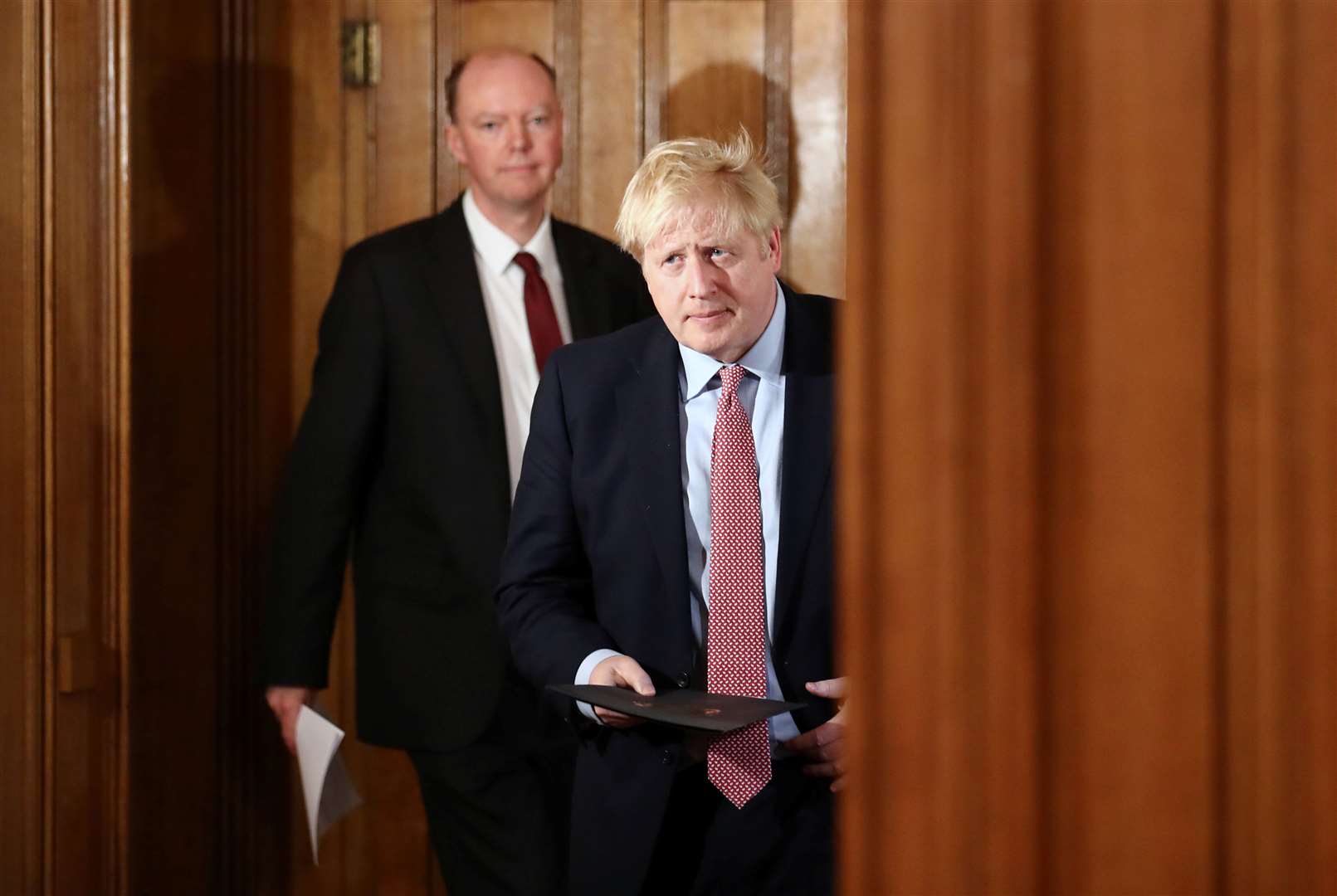 Mr Johnson arrives to speak at another news conference on March 12, followed by chief medical officer Sir Chris Whitty (Simon Dawson/PA)