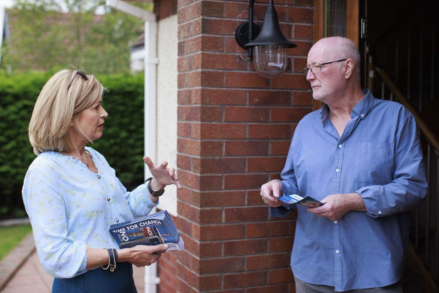 Diana Armstrong speaking to householder Michael McConville during canvassing in Enniskillen (Liam McBurney/PA)