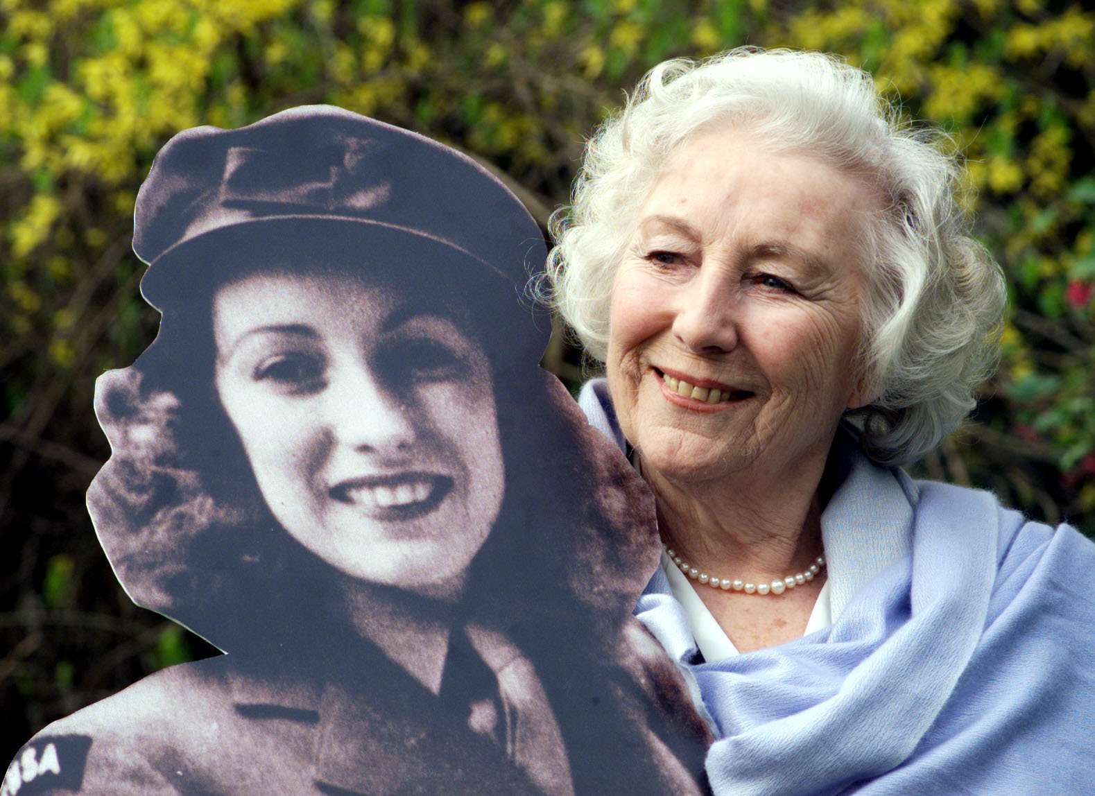 Dame Vera Lynn with an image of herself during the war (Sean Dempsey/PA)