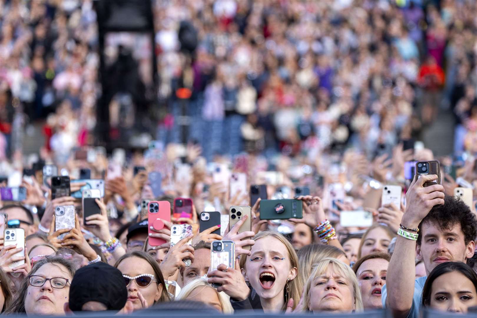 Music fans watch Taylor Swift perform on stage during her Eras tour at Murrayfield Stadium in Edinburgh on June 7 (Jane Barlow/PA)