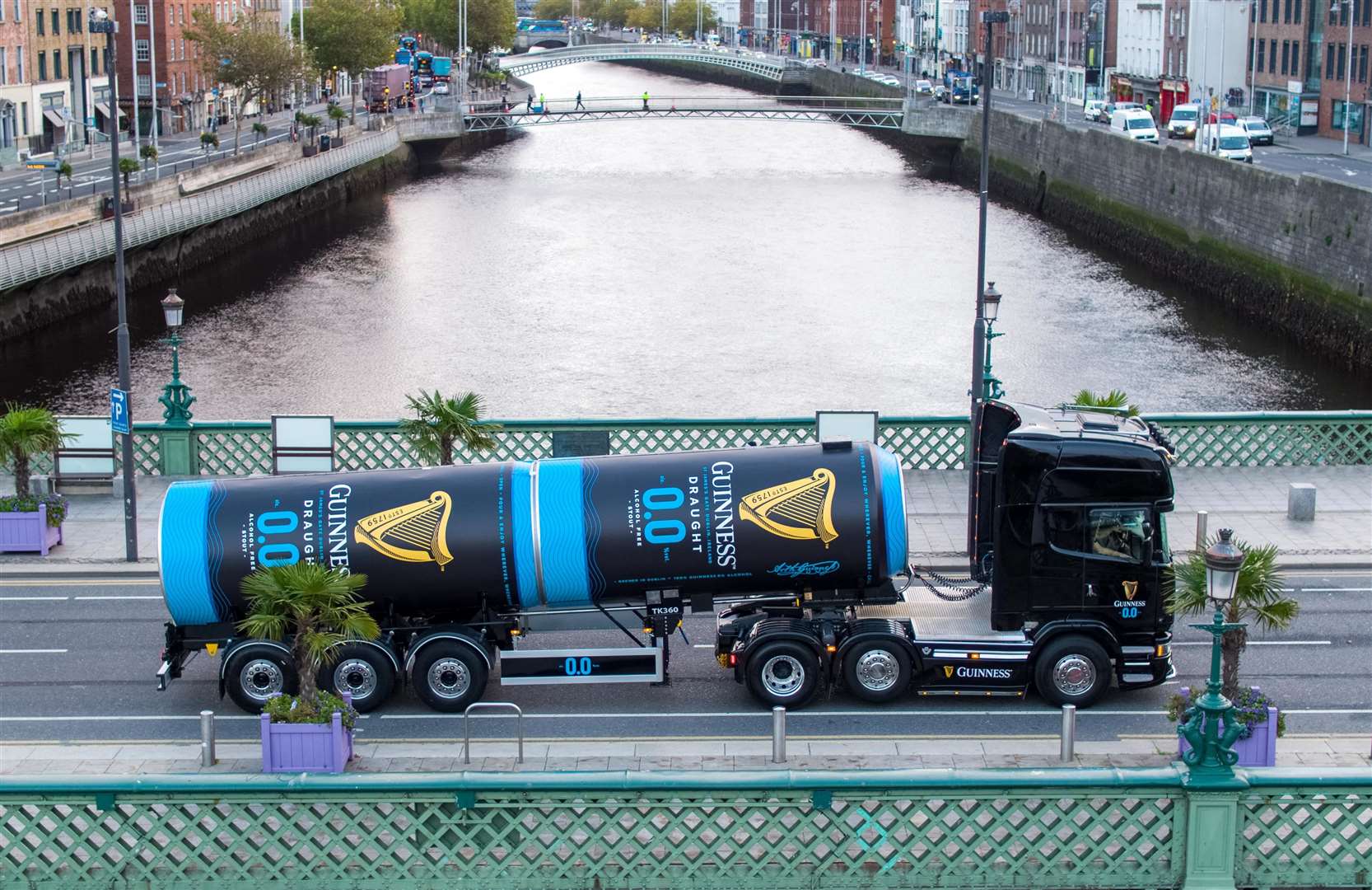 A Guinness tanker filled with alcohol-free stout crosses a Dublin bridge after leaving the St James’s Gate brewery (Aerial Photography Ireland/Andres Poveda/PA)