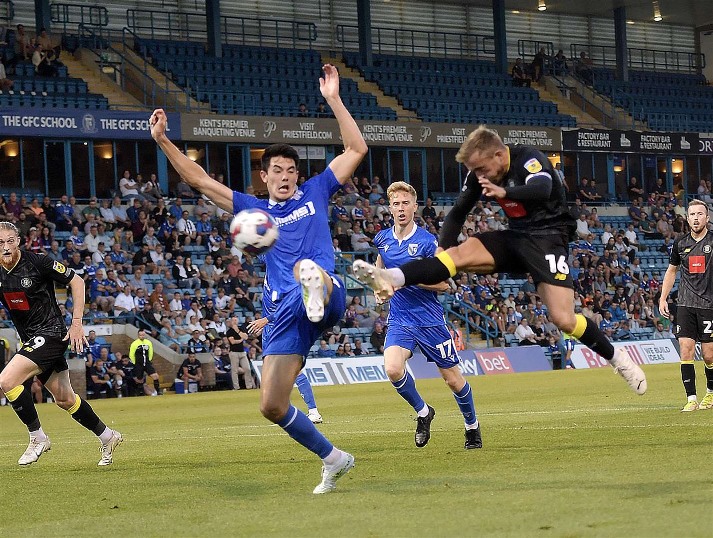 Elkan Baggott attempts to stop Harrogate captain Alex Pattison during Gillingham's home loss to Harrogate on Tuesday night. Picture: Beau Goodwin