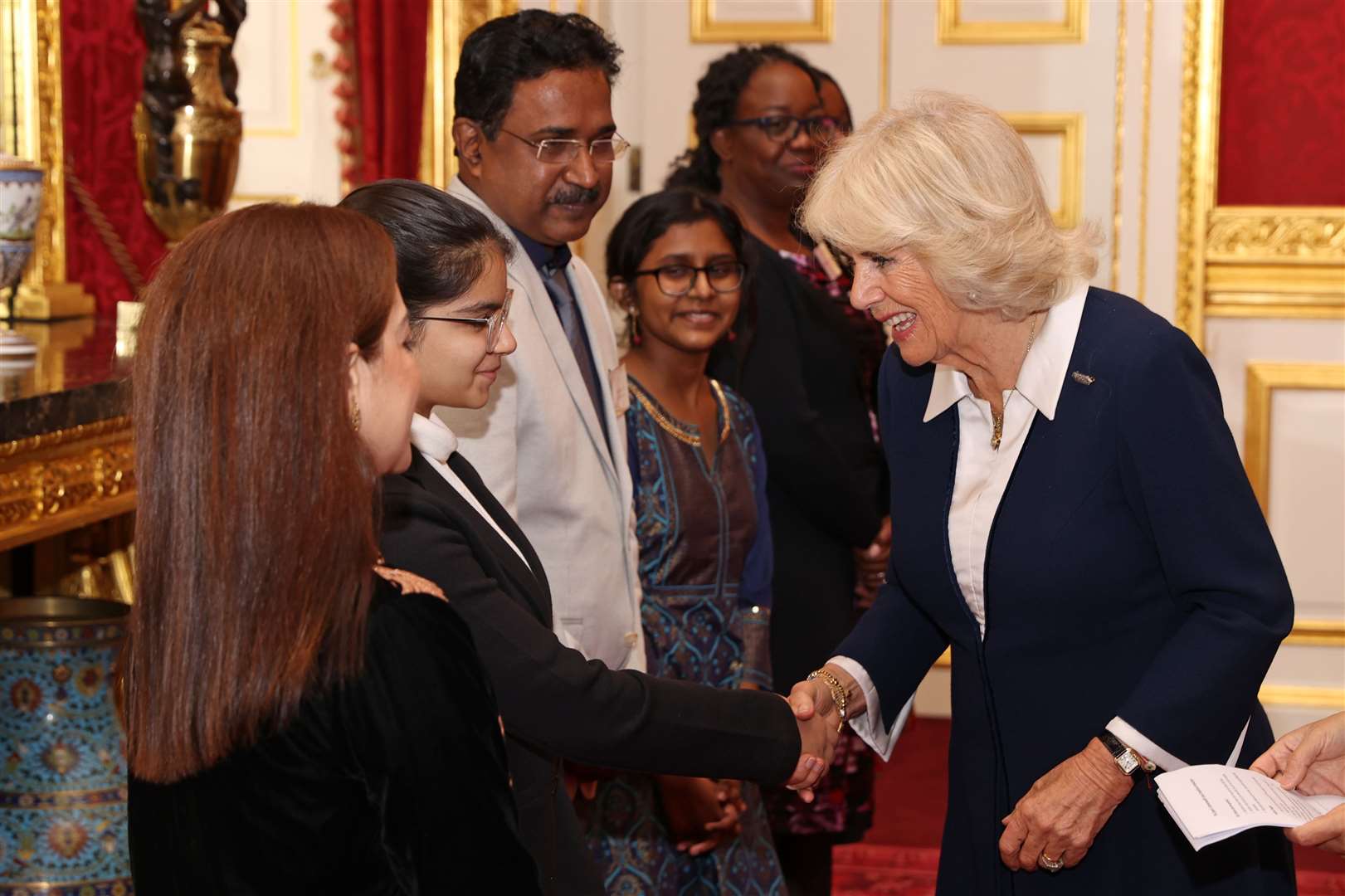 The Duchess of Cornwall meets Junior Runner-up, Raisa Gulati during the event (Chris Jackson/PA)