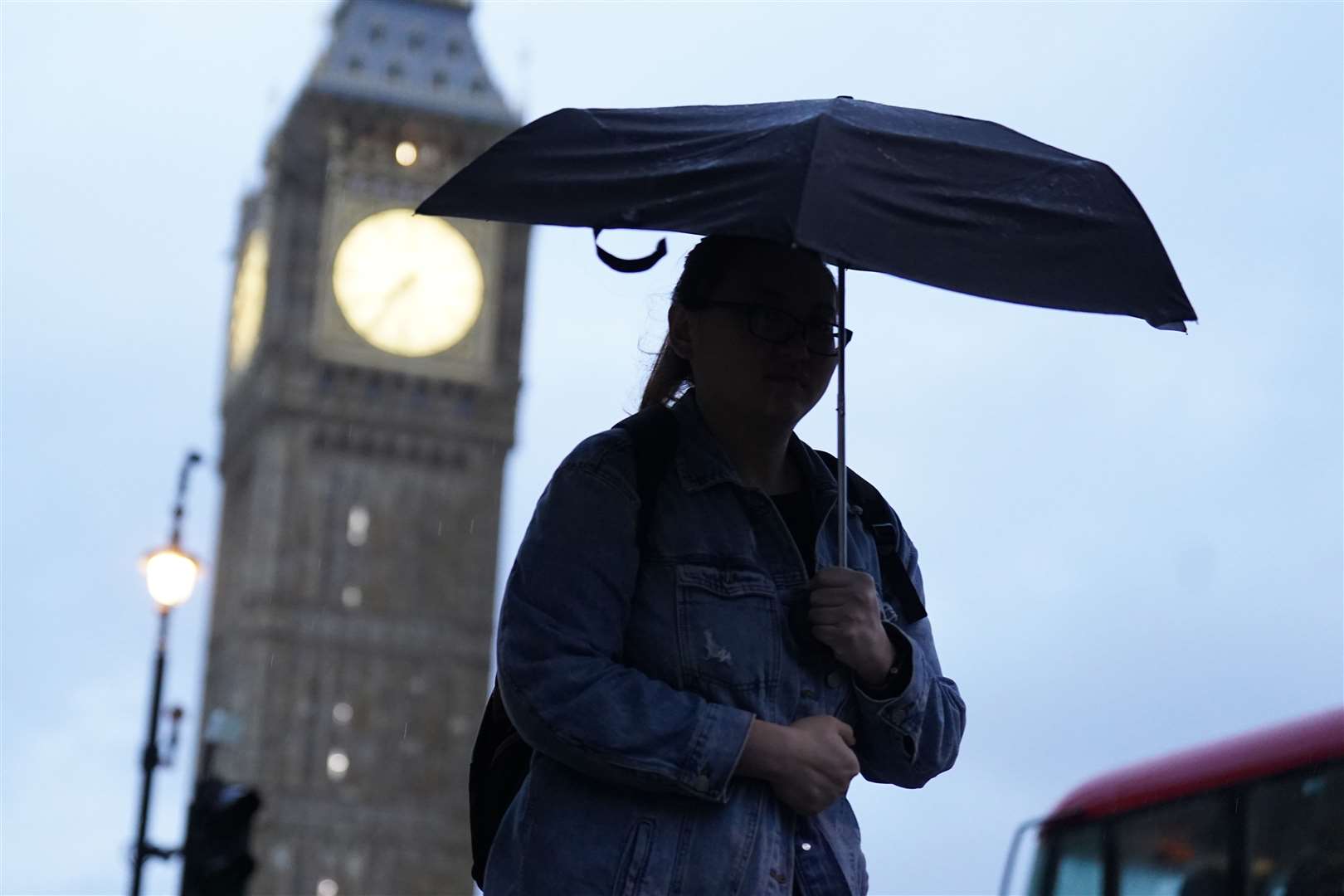 A lady walks with an umbrella near Parliament Square in Westminster, London (James Manning/PA)