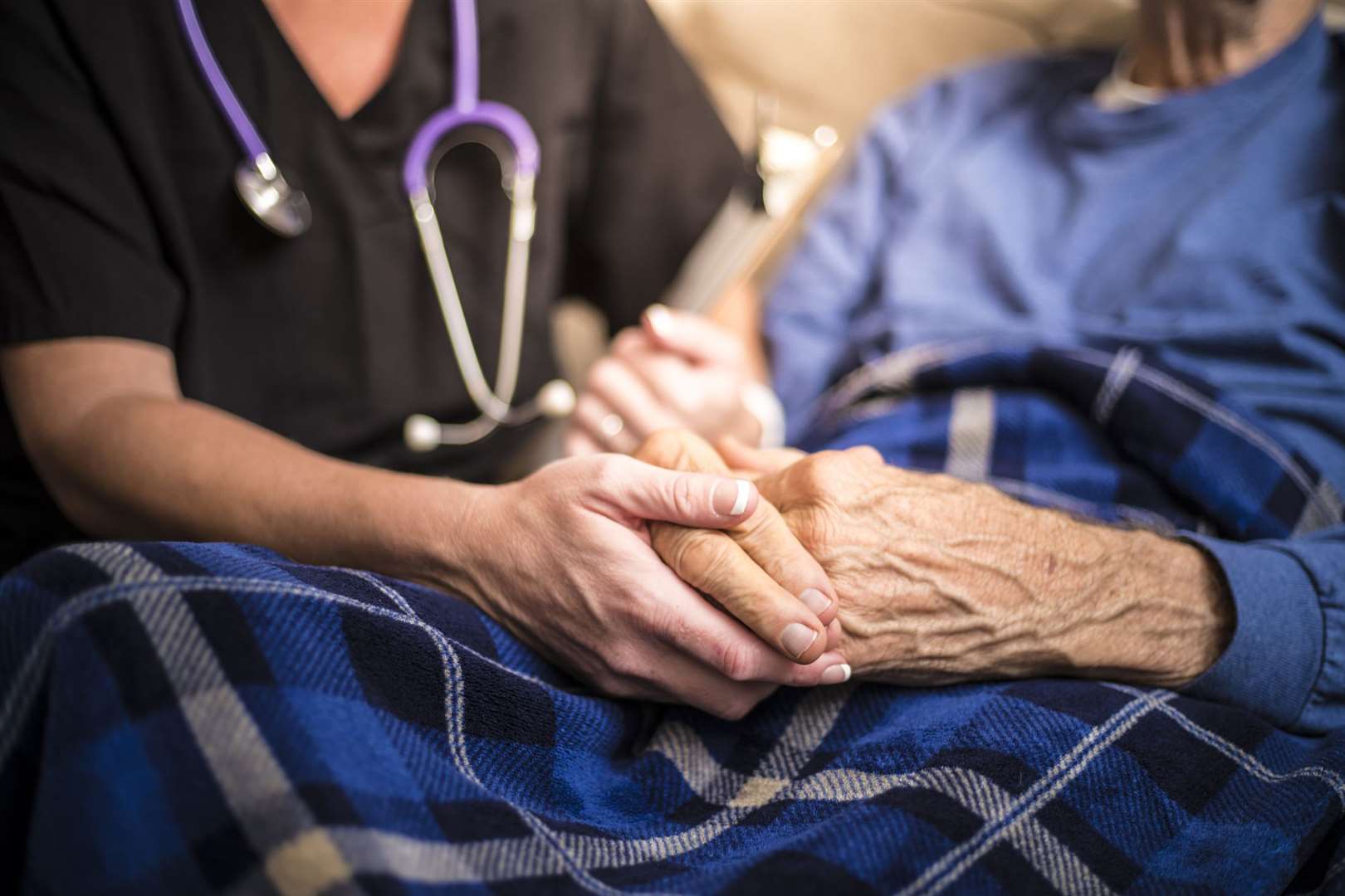 Nurse helping elderly patient. Stock photo