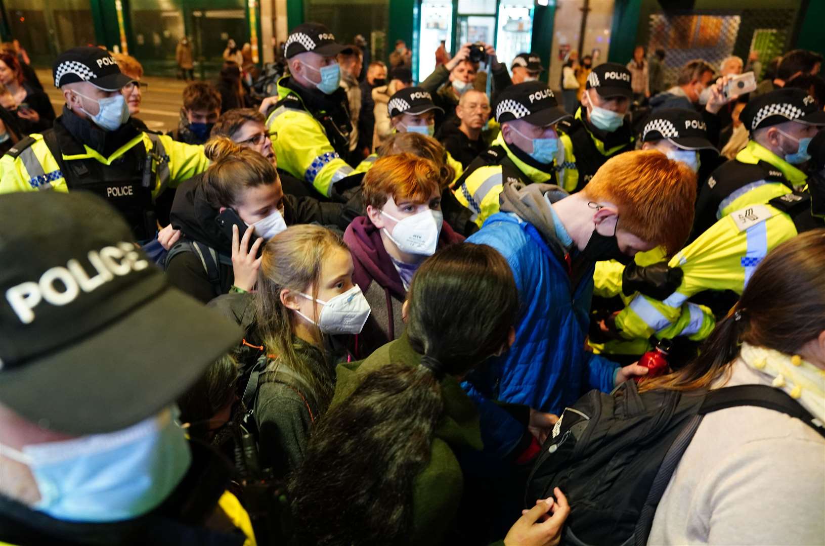 Greta Thunberg was surrounded by police as she was escorted out of the station (Jane Barlow/PA)