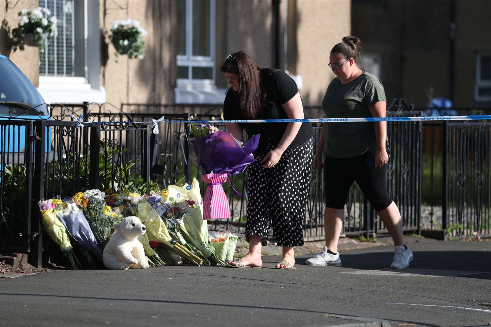 Flowers placed at the scene on Renfrew Road in Paisley (Andrew Milligan/PA)