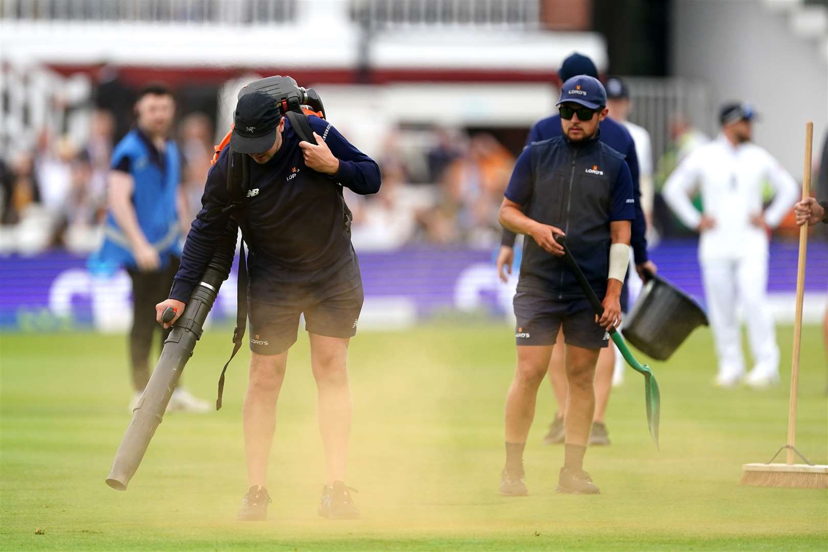 Ground staff cleaning up orange powder thrown by the protesters (Mike Egerton/PA)