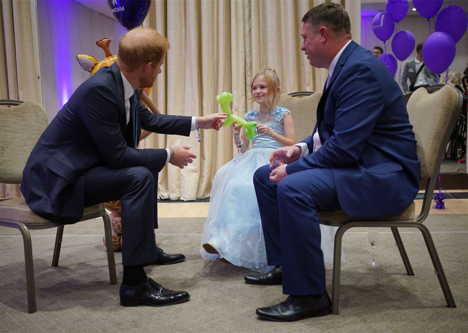 The Duke of Sussex speaks to Poppy and her father Daniel Higham during the 2023 WellChild awards (Yui Mok/PA)