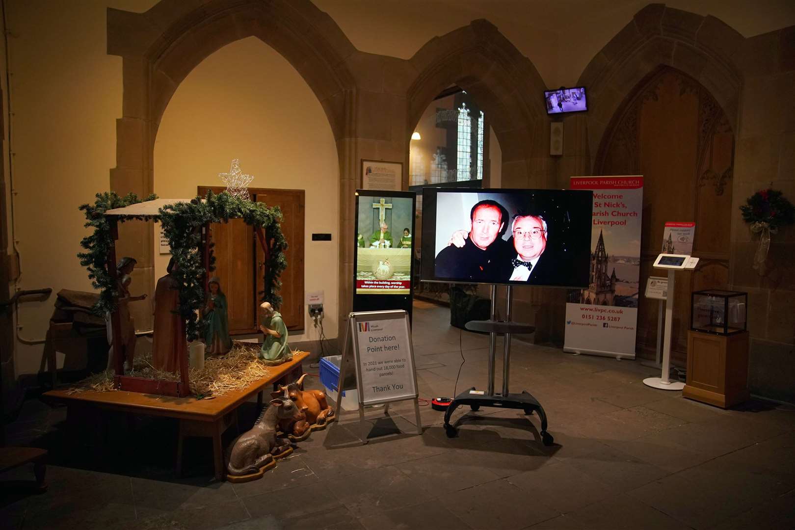 A photo is displayed on a screen ahead of the funeral for former Brookside actor Dean Sullivan (Peter Byrne/PA)