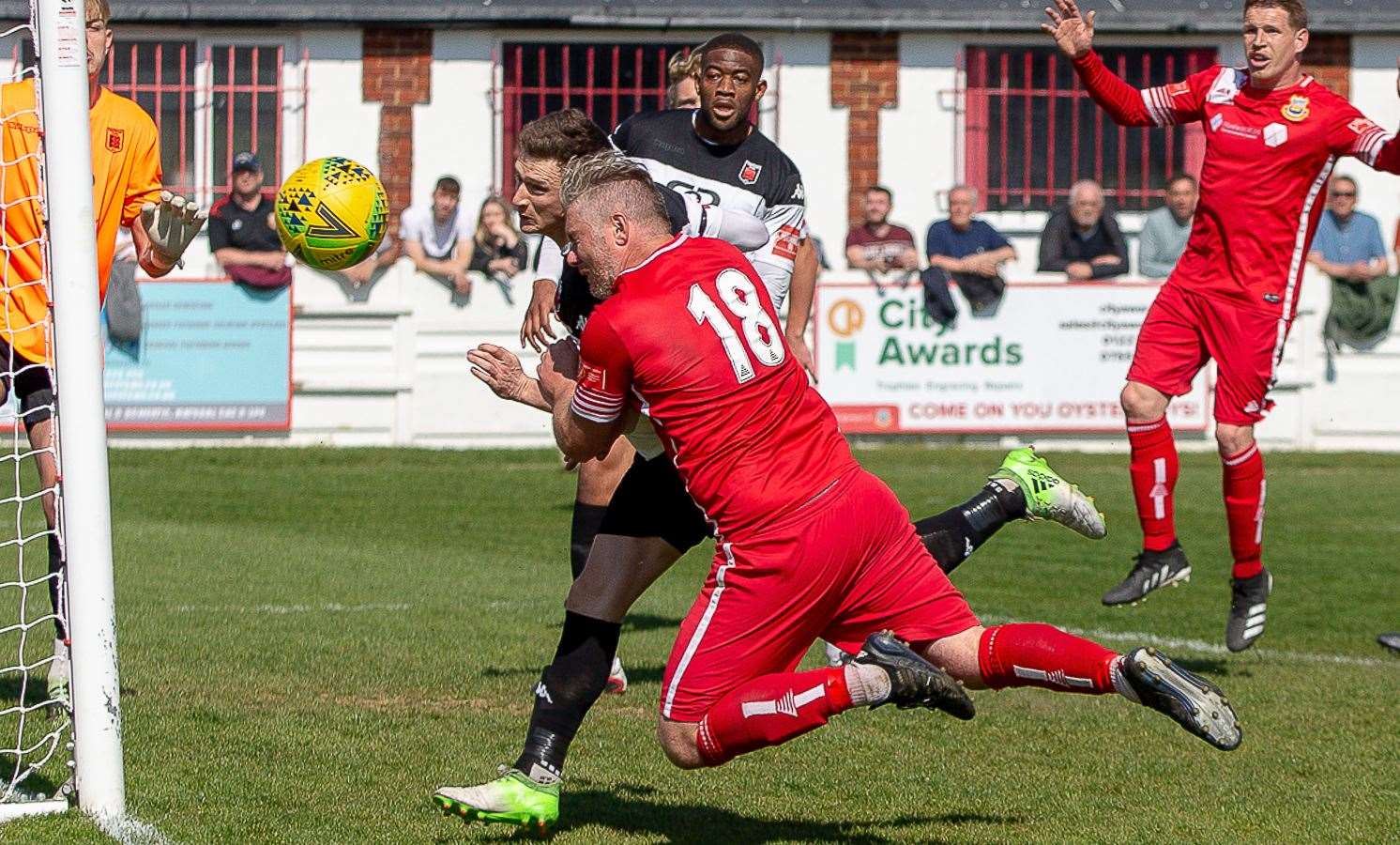 Sam Bewick beats former Faversham striker Harry Goodger to the ball in the Lilywhites' recent win over Whitstable. Picture: Les Biggs