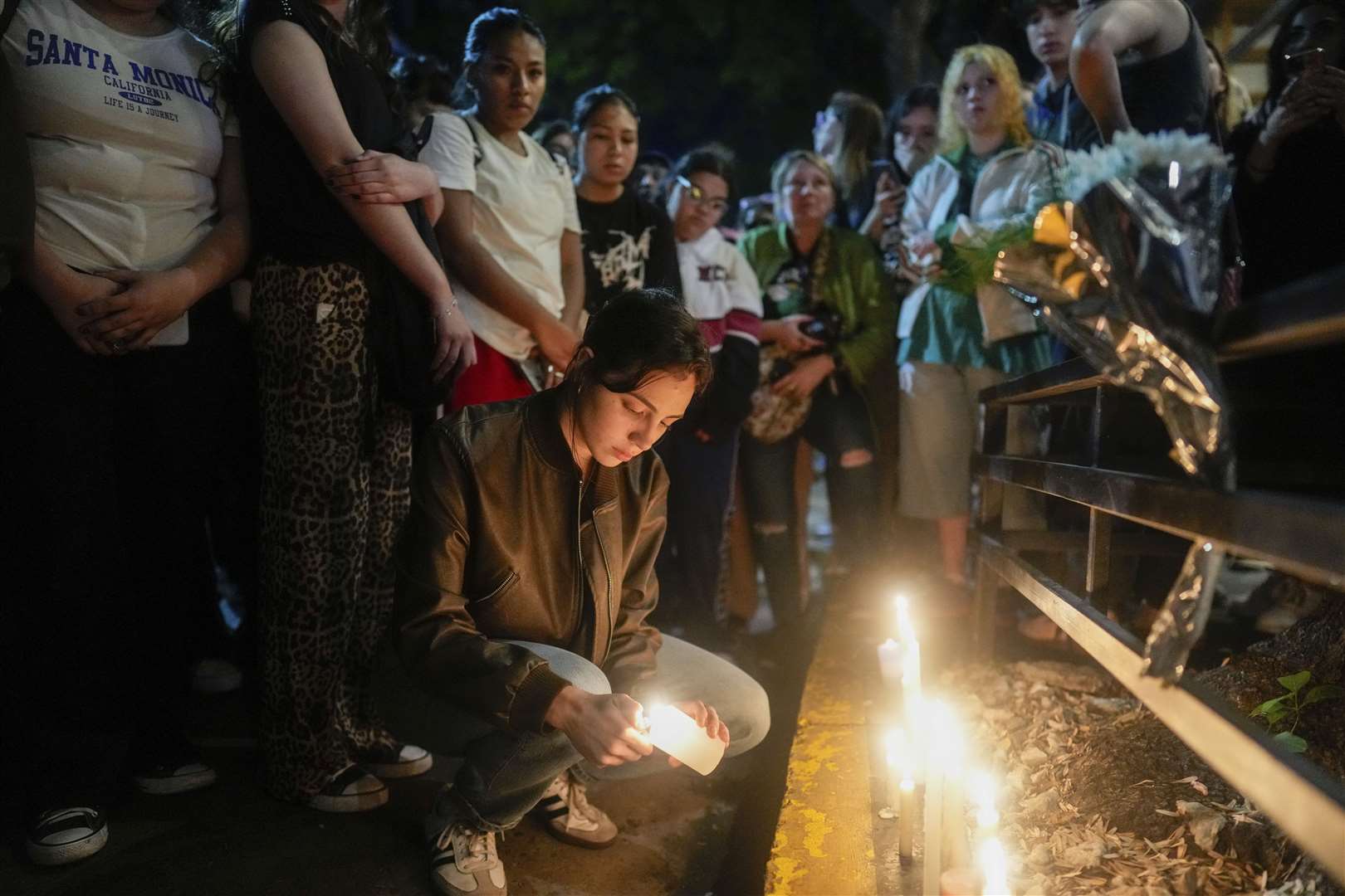 Fans light candles outside the hotel where former One Direction singer Liam Payne died (Natacha Pisarenko/AP)