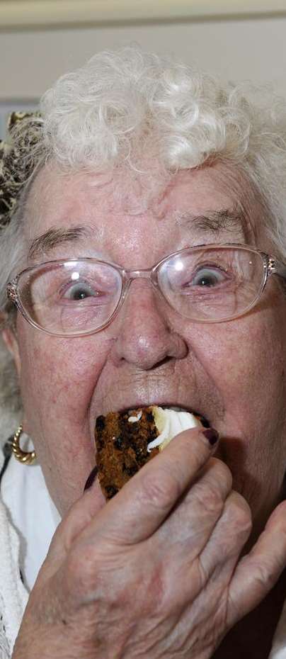 Dolly Grist enjoying her cake at The Centre, Sandwich