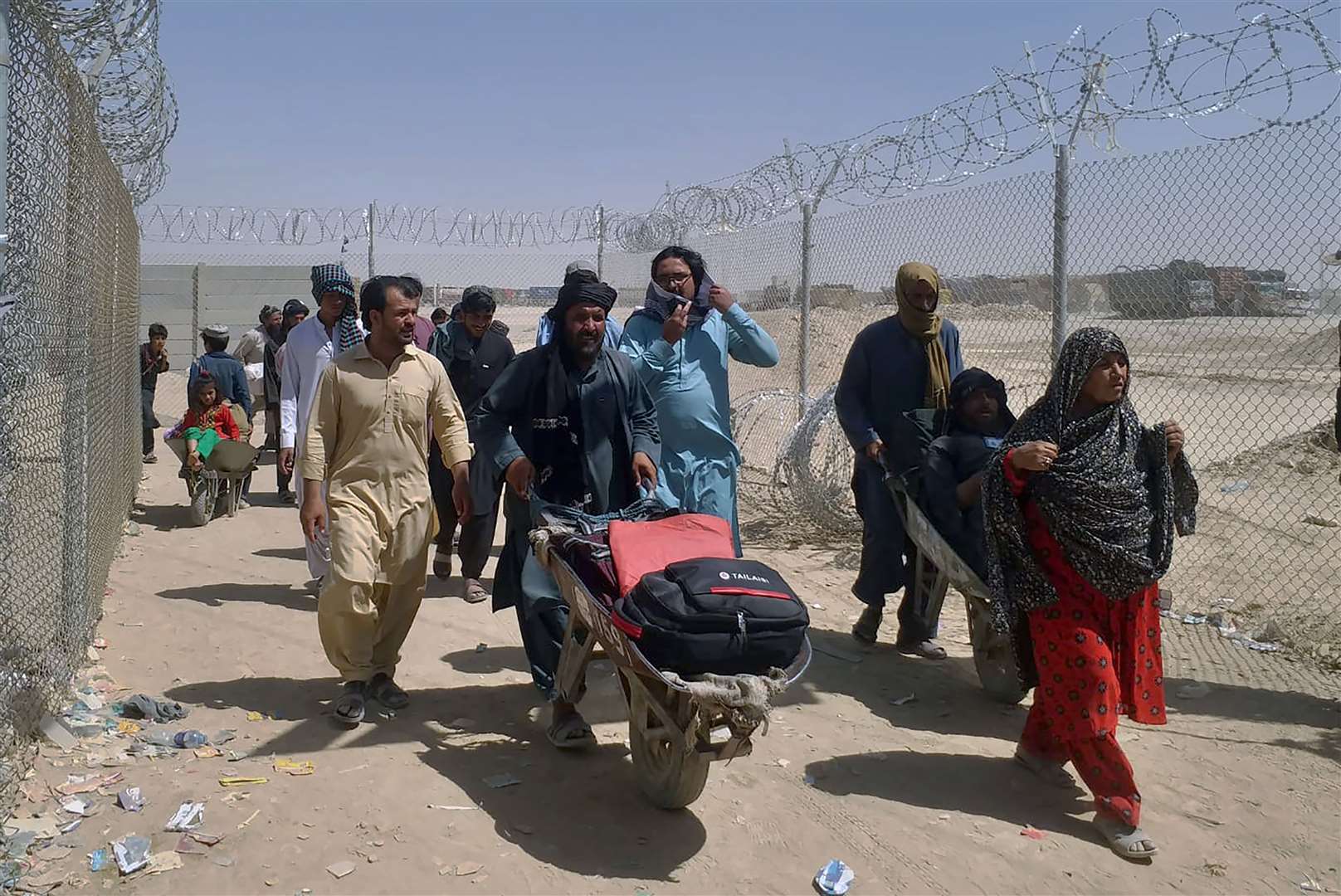 Afghan families enter Pakistan through a border crossing point in Chaman (Jafar Khan/AP)