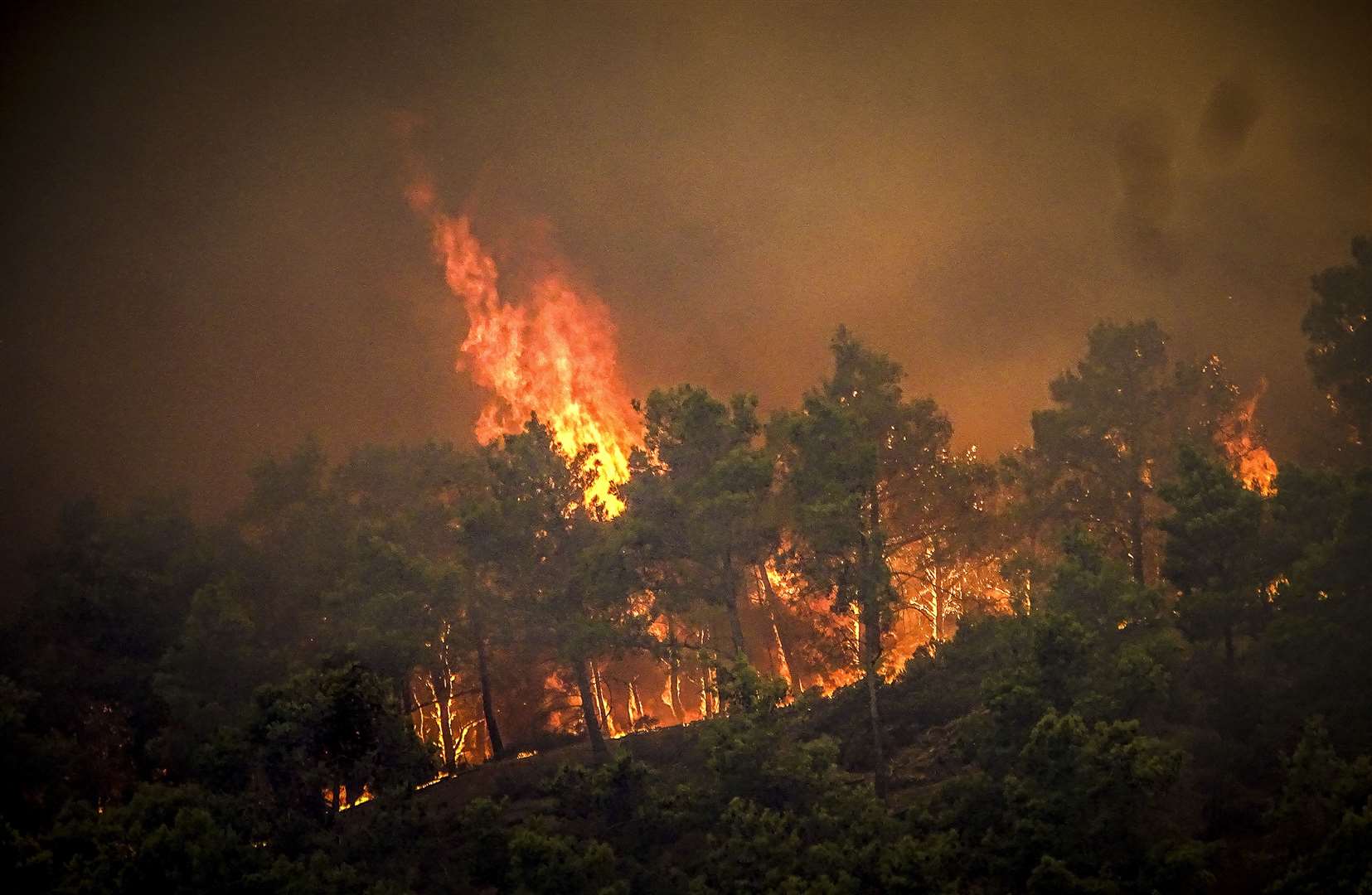 A wildfire is burning on the Greek island of Rhodes for a fifth day (Argyris Mantikos/AP)