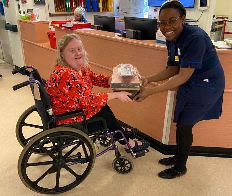 Natalie giving a present to the ward matron before leaving the QEQM