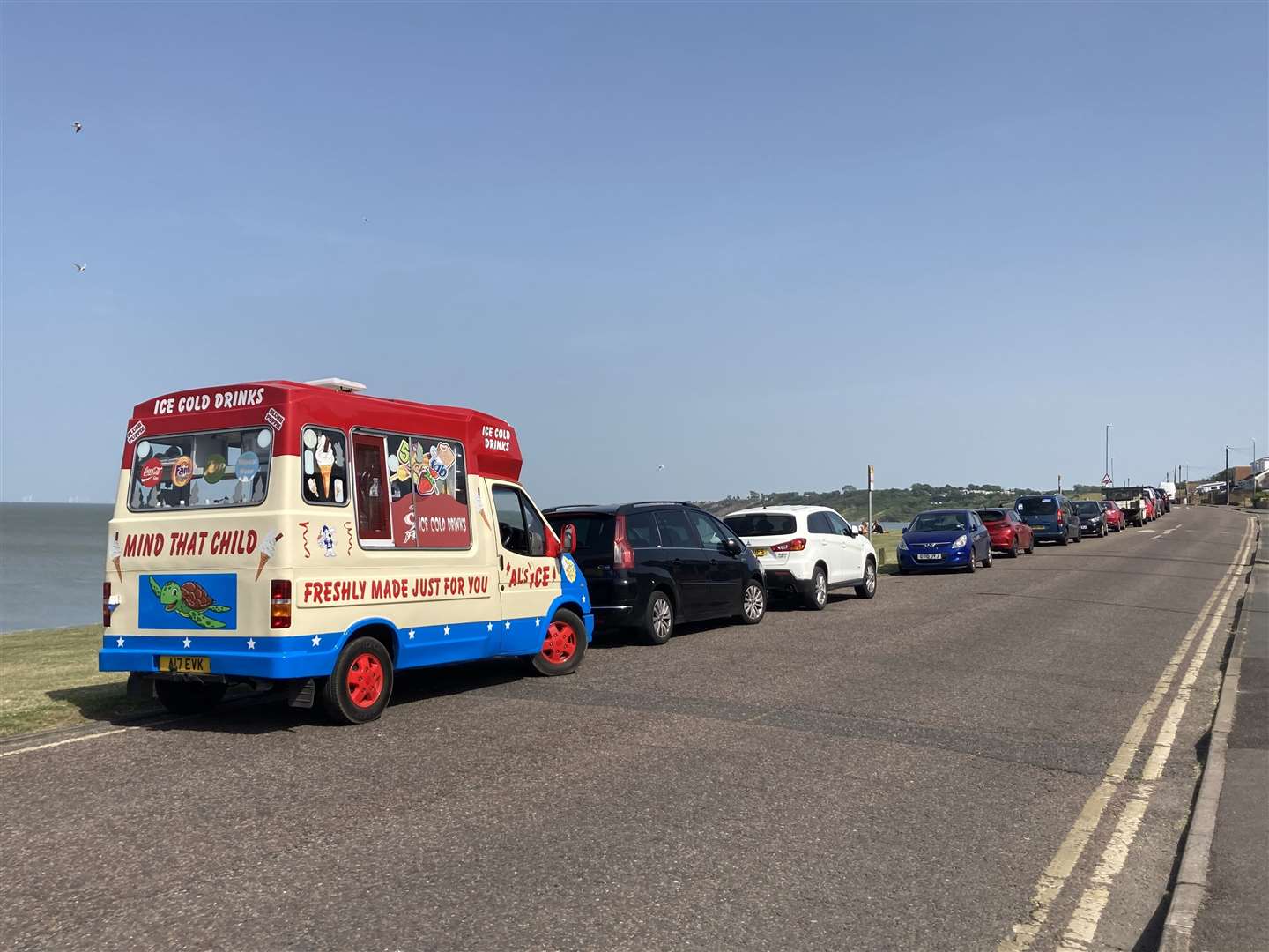 Vehicles – including a much-needed ice cream van – set up along the shore. Photo: John Nurden