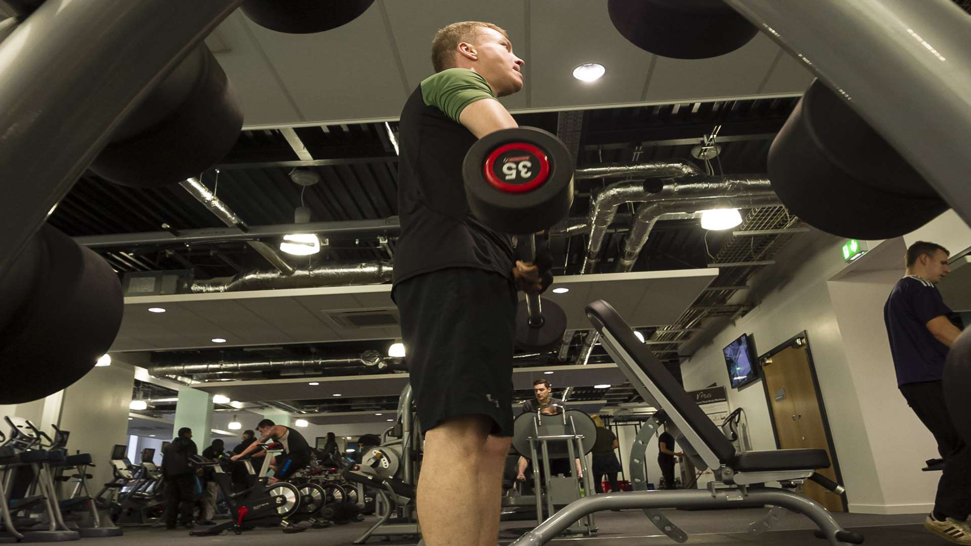 Dan Unthank lifting weights in the gym.