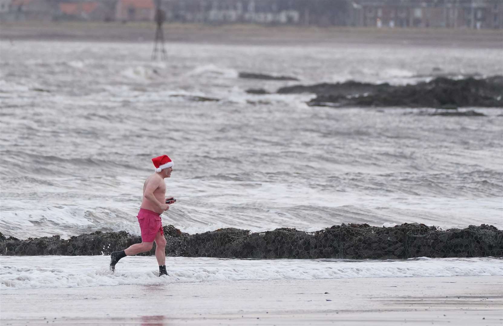 Santa ditched some of his costume for a Christmas Day dip (Andrew Milligan/PA)