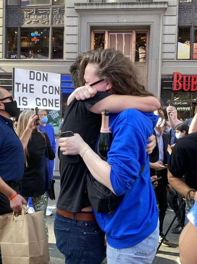 Emotions were high as people celebrated in Times Square, New York, following Mr Biden’s win (PA)